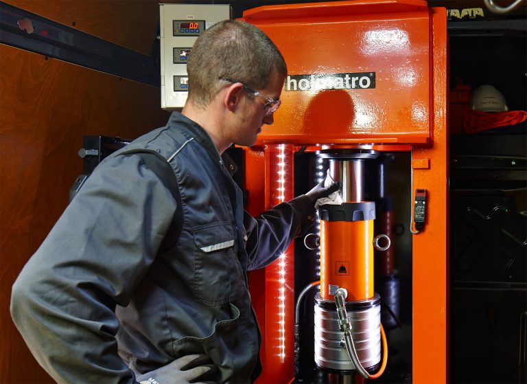 Worker performing equipment testing on a Holmatro machine.