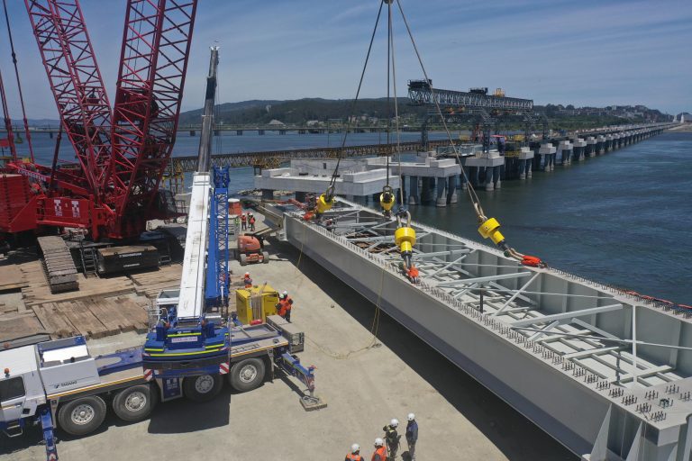 A SyncHoist is attached to an assymetrical bridge beam to construct a new railway bridge on the Biobio River in Chile, South America.