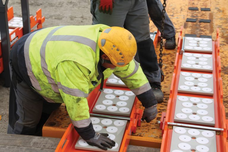 Worker wearing safety helmet using the skidding system during the project.